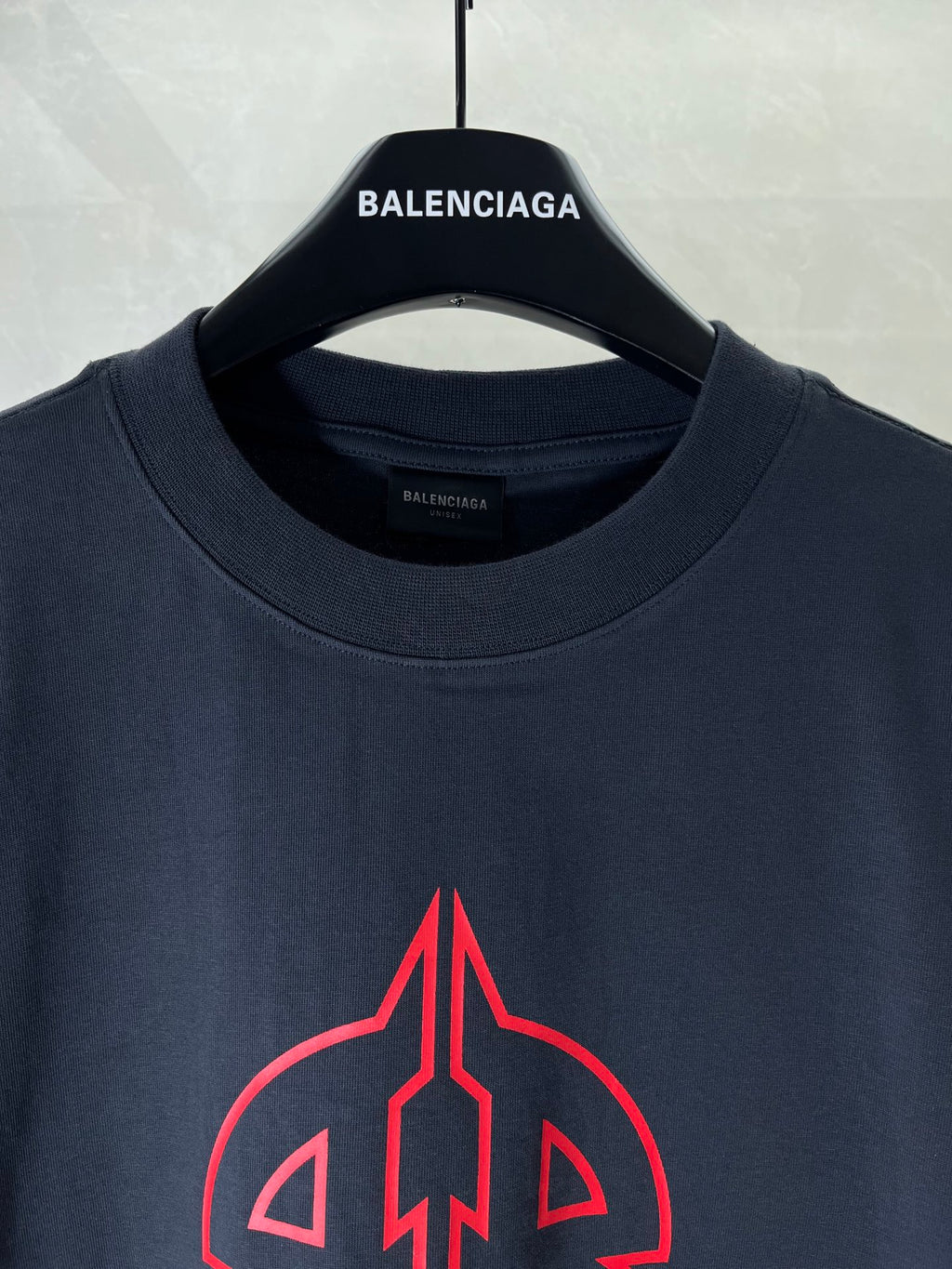 Dark navy T-shirt neckline with BALENCIAGA logo label at the collar.
