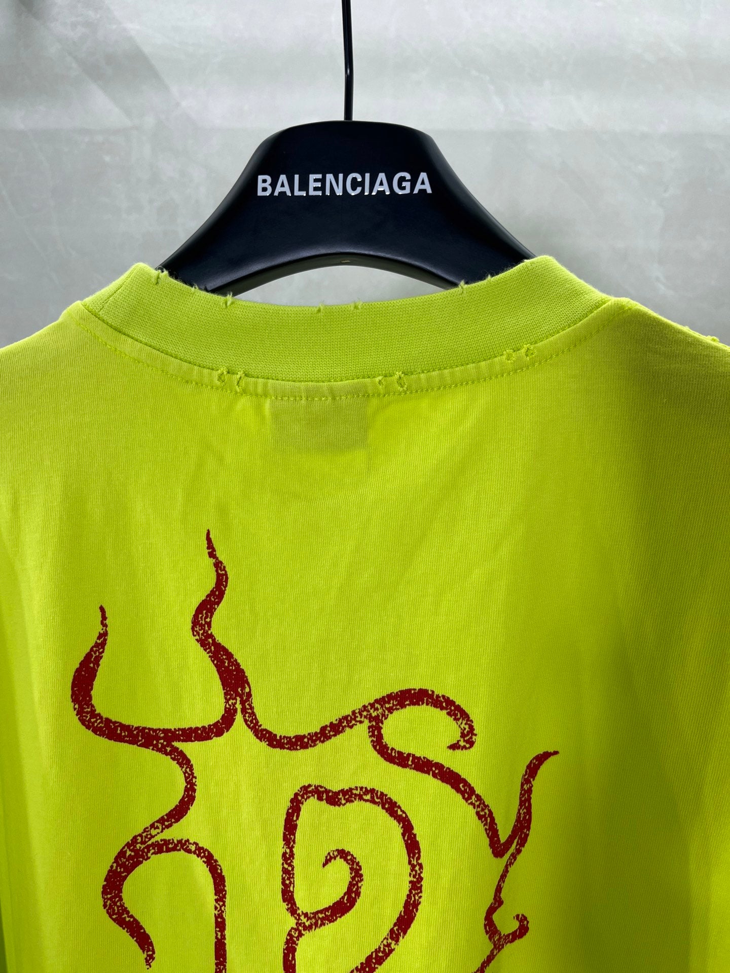 Lime green T-shirt close-up of neckline and red front graphic