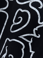 Black shirt with partial white logo text graphic detail