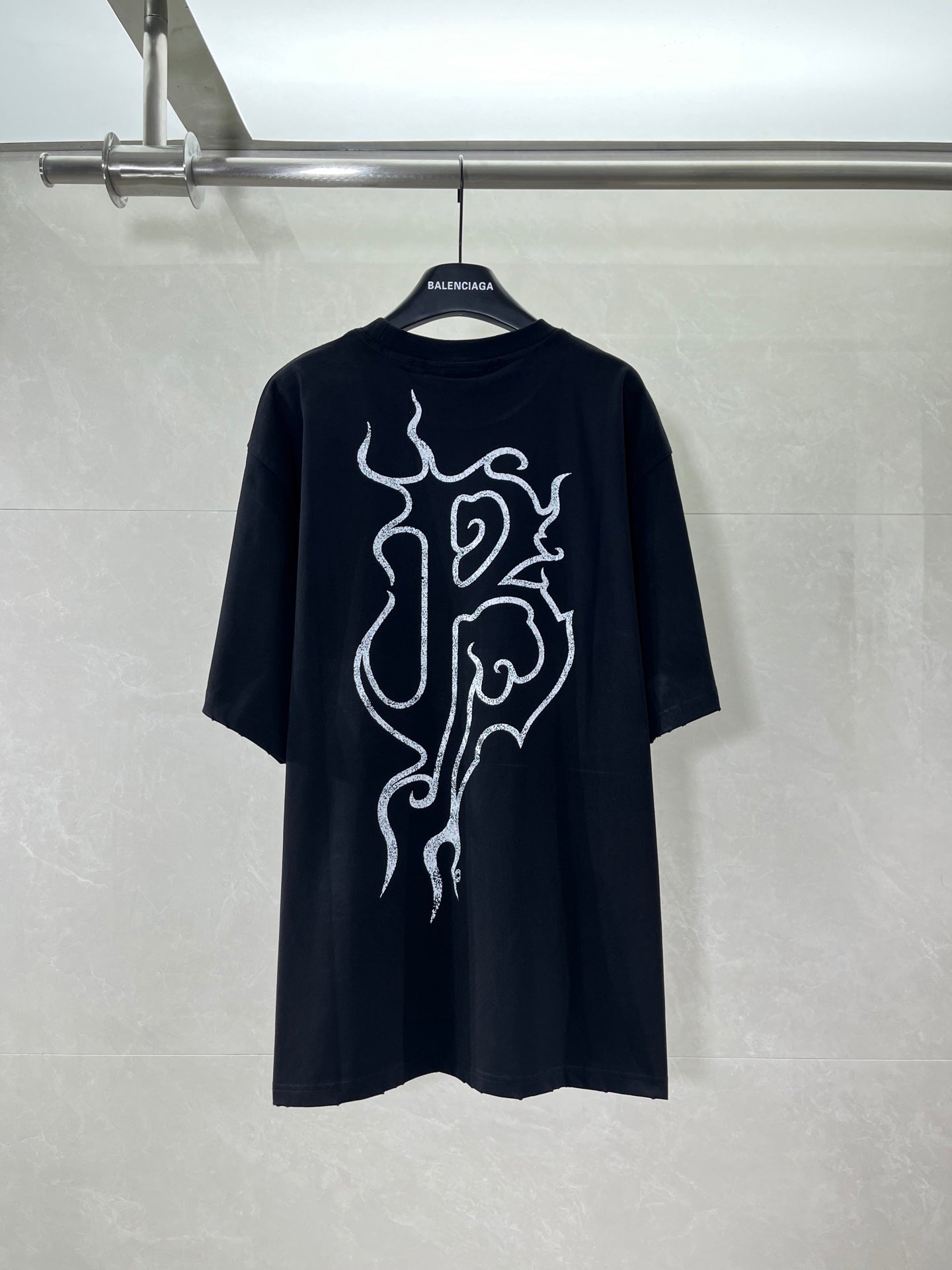 Black short-sleeve shirt with large white back graphic