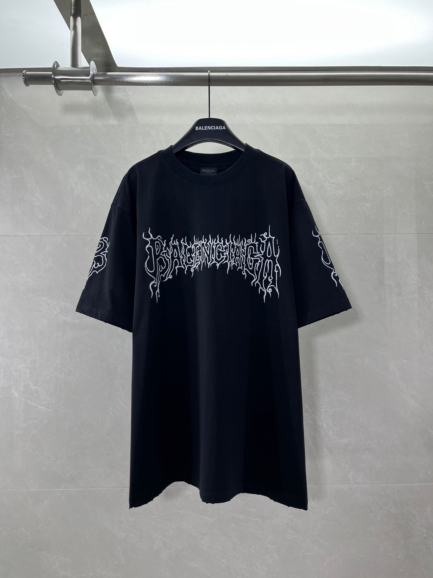 Black short-sleeve shirt with white graphic logo on front