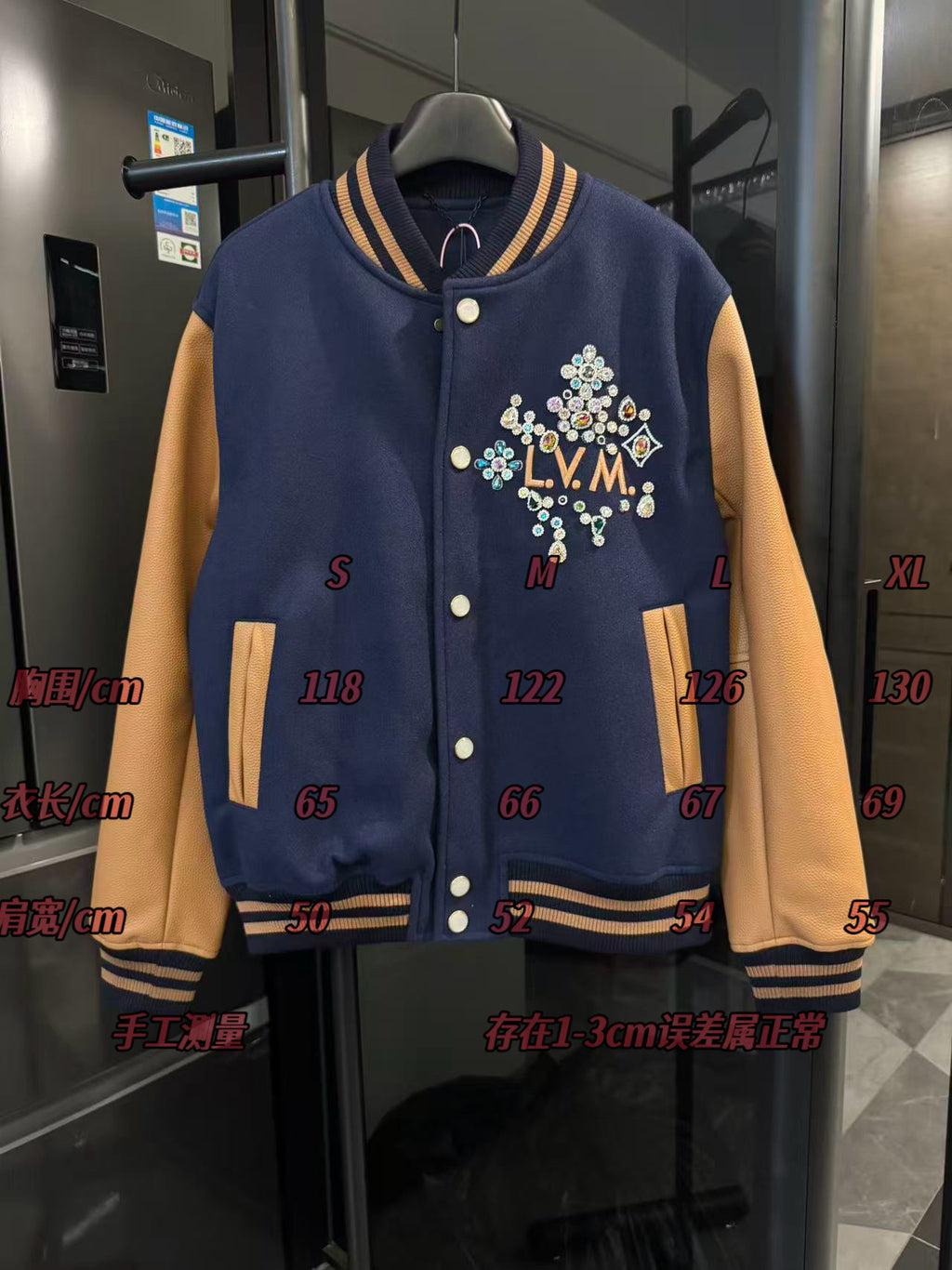 Long varsity jacket front with LV crest, gold snaps, and size measurement markings on display