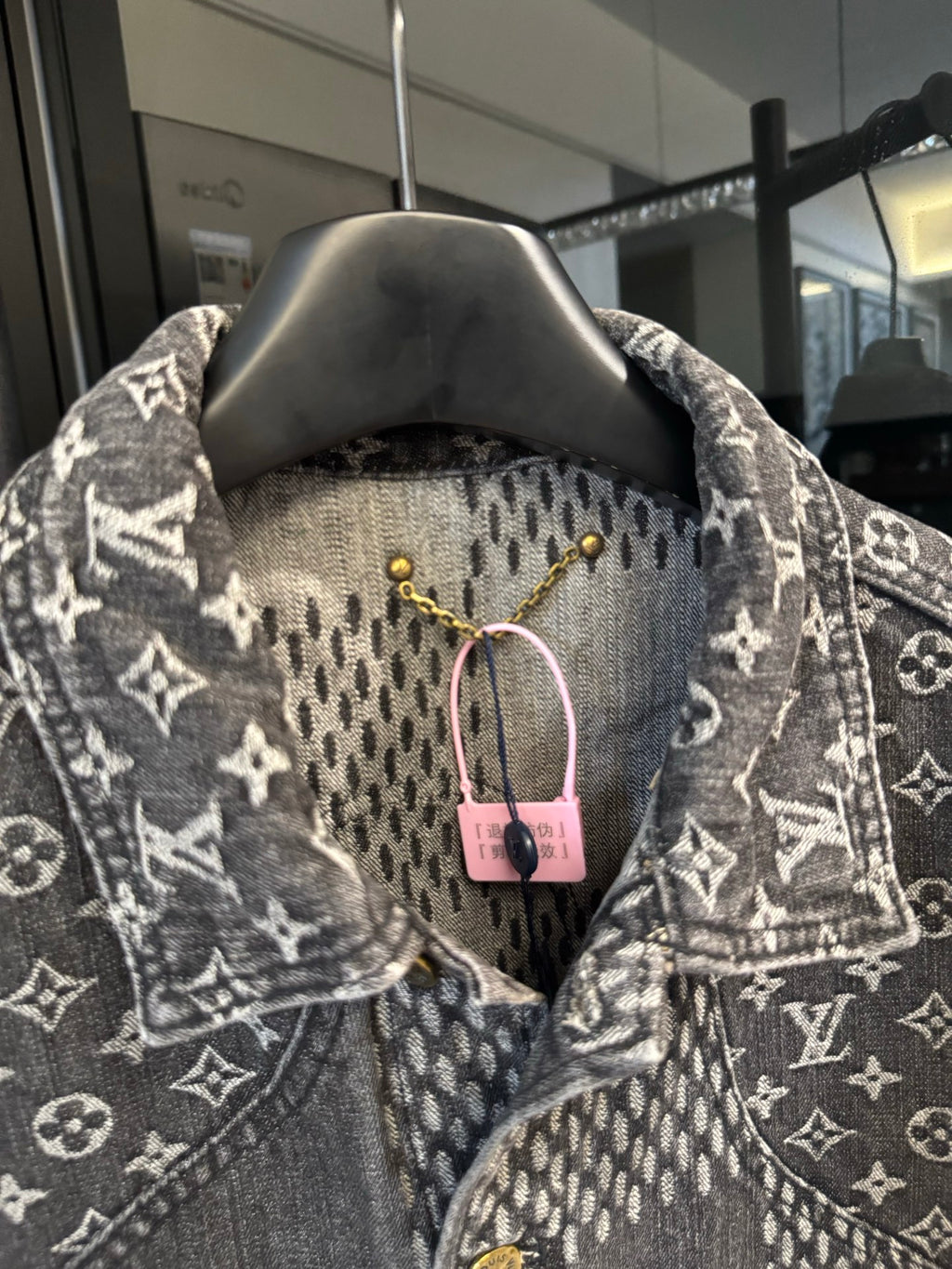 Louis Vuitton denim jacket close-up of check yoke and monogram collar, gold buttons