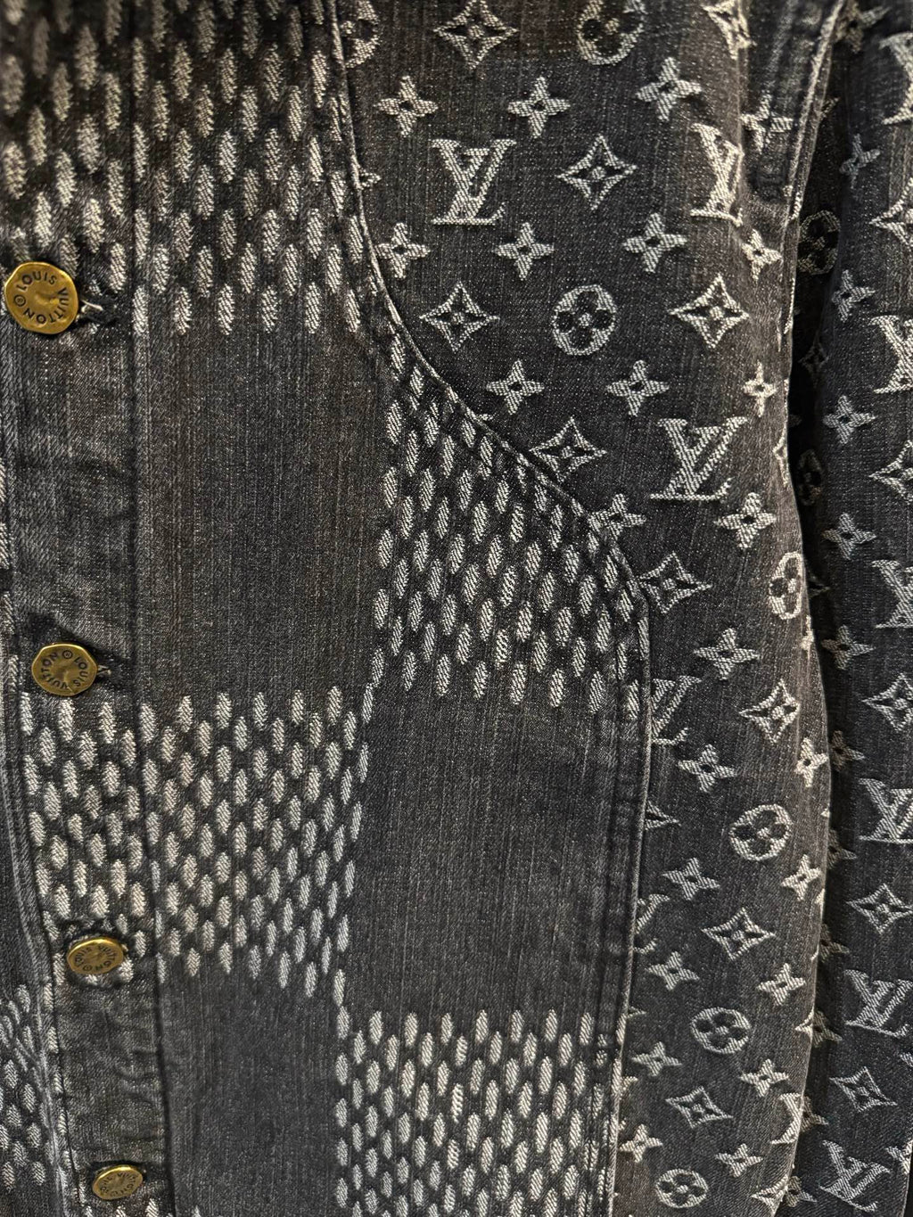 Louis Vuitton denim jacket close-up of monogram pattern and gold button detail