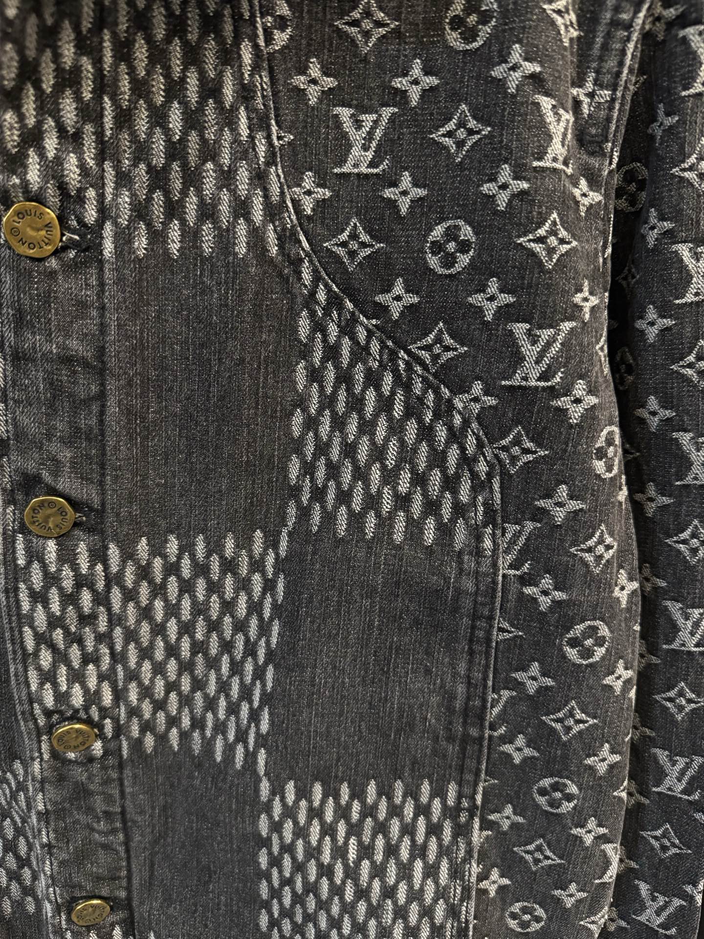 Louis Vuitton denim jacket close-up of monogram pattern and gold button detail