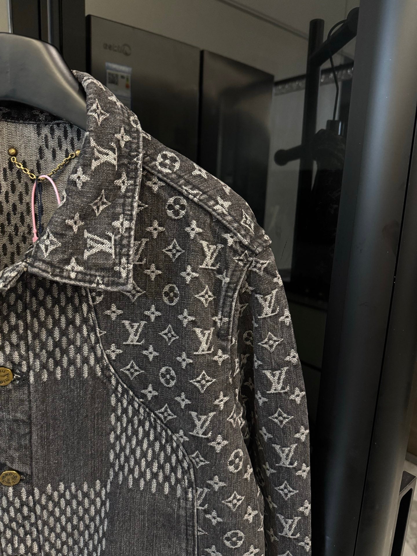 Louis Vuitton denim jacket side view with monogram print and gold button placket