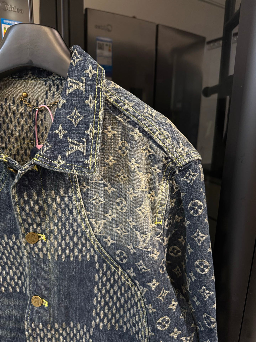Louis Vuitton monogram denim jacket sleeve with gold button and contrast stitching