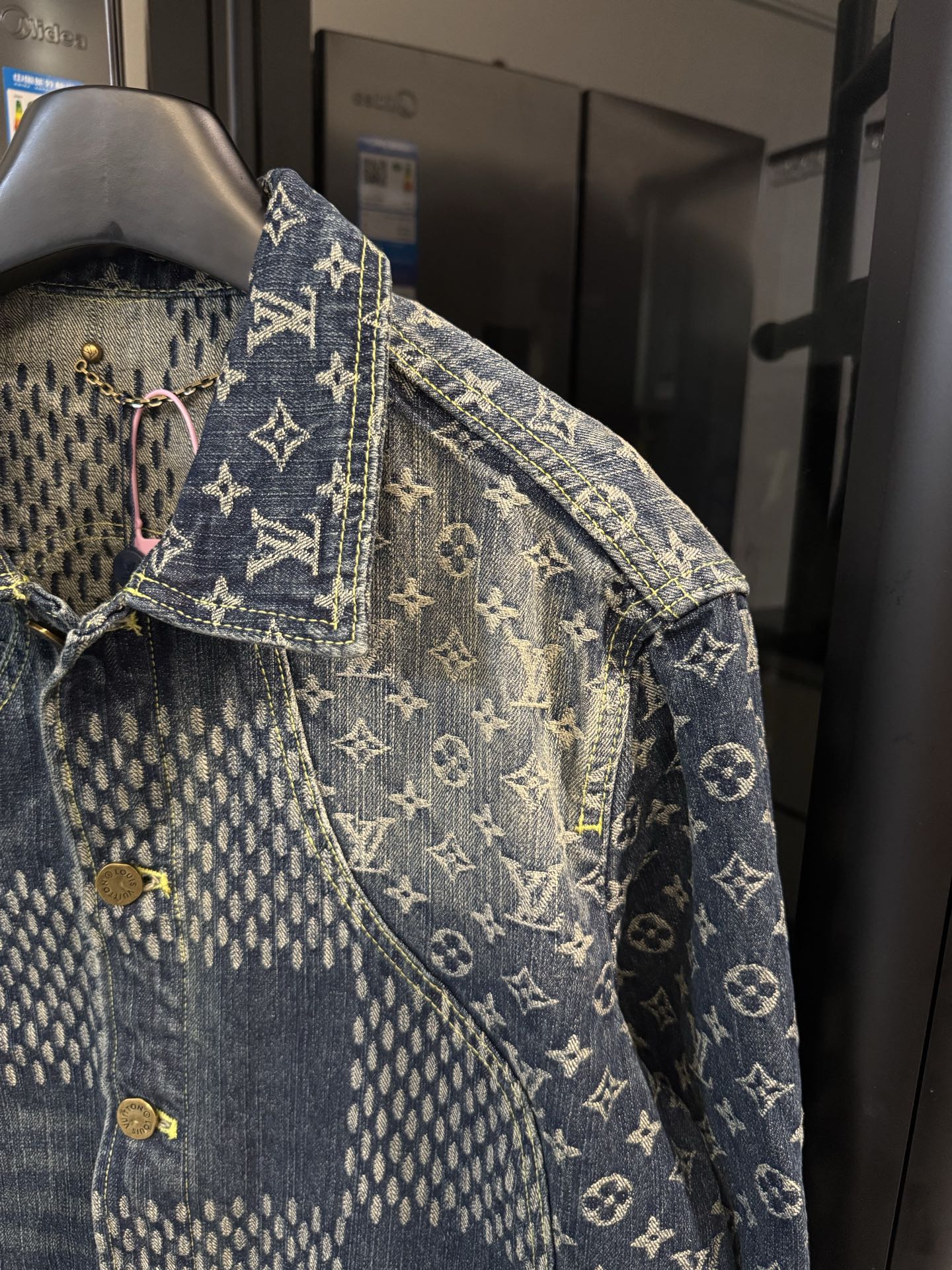 Louis Vuitton monogram denim jacket sleeve with gold button and contrast stitching