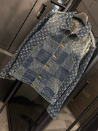 Louis Vuitton monogram denim jacket close-up with yellow snap buttons