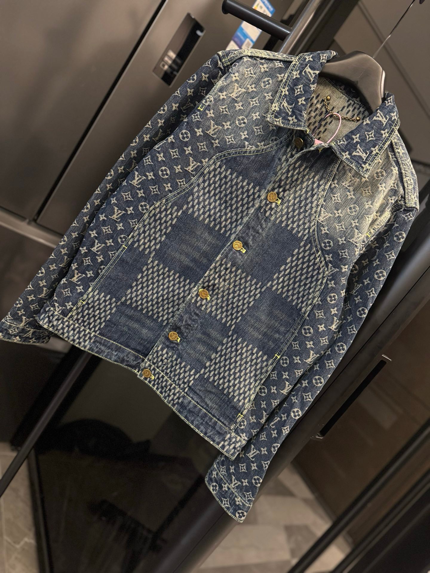Louis Vuitton monogram denim jacket close-up with yellow snap buttons