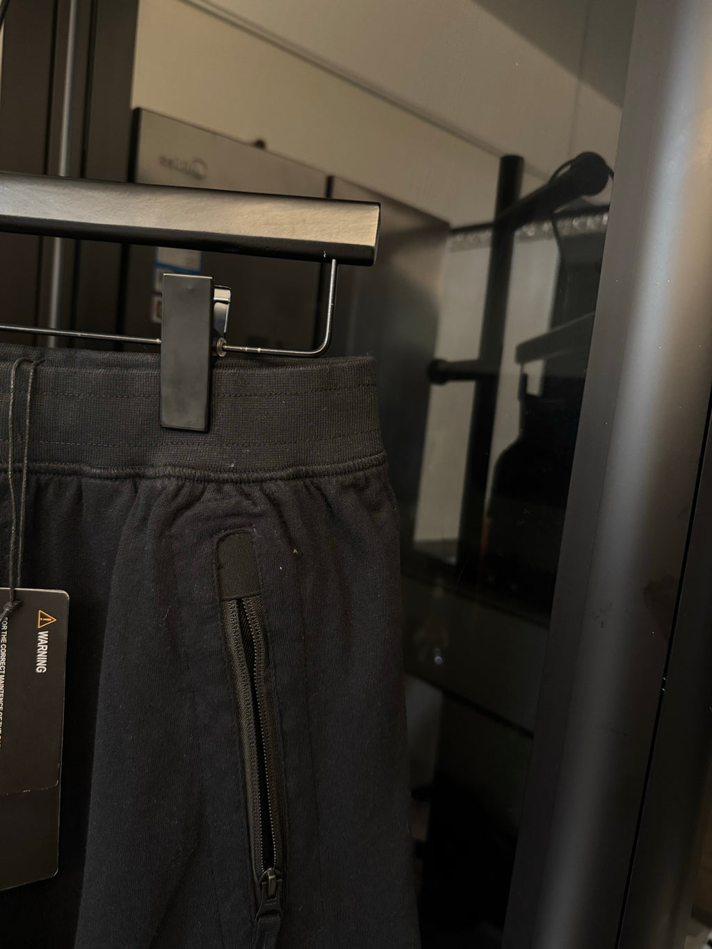 Stone Island cargo trousers detail, dark gray with front zipper pocket and drawstring cord