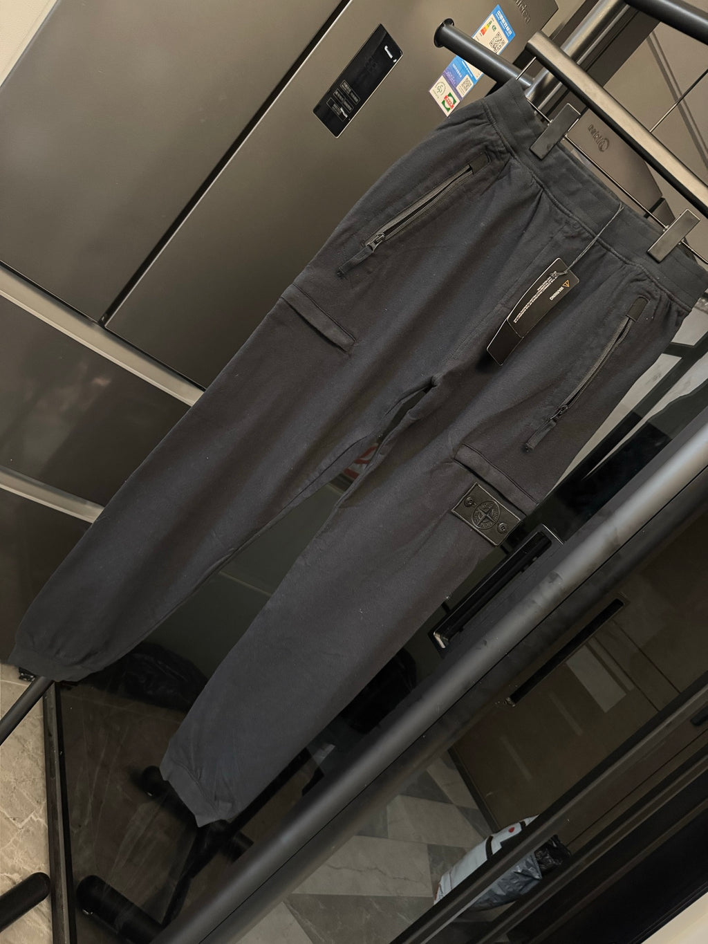 Stone Island cargo trousers, dark gray fabric with front zipper fly and utility pockets