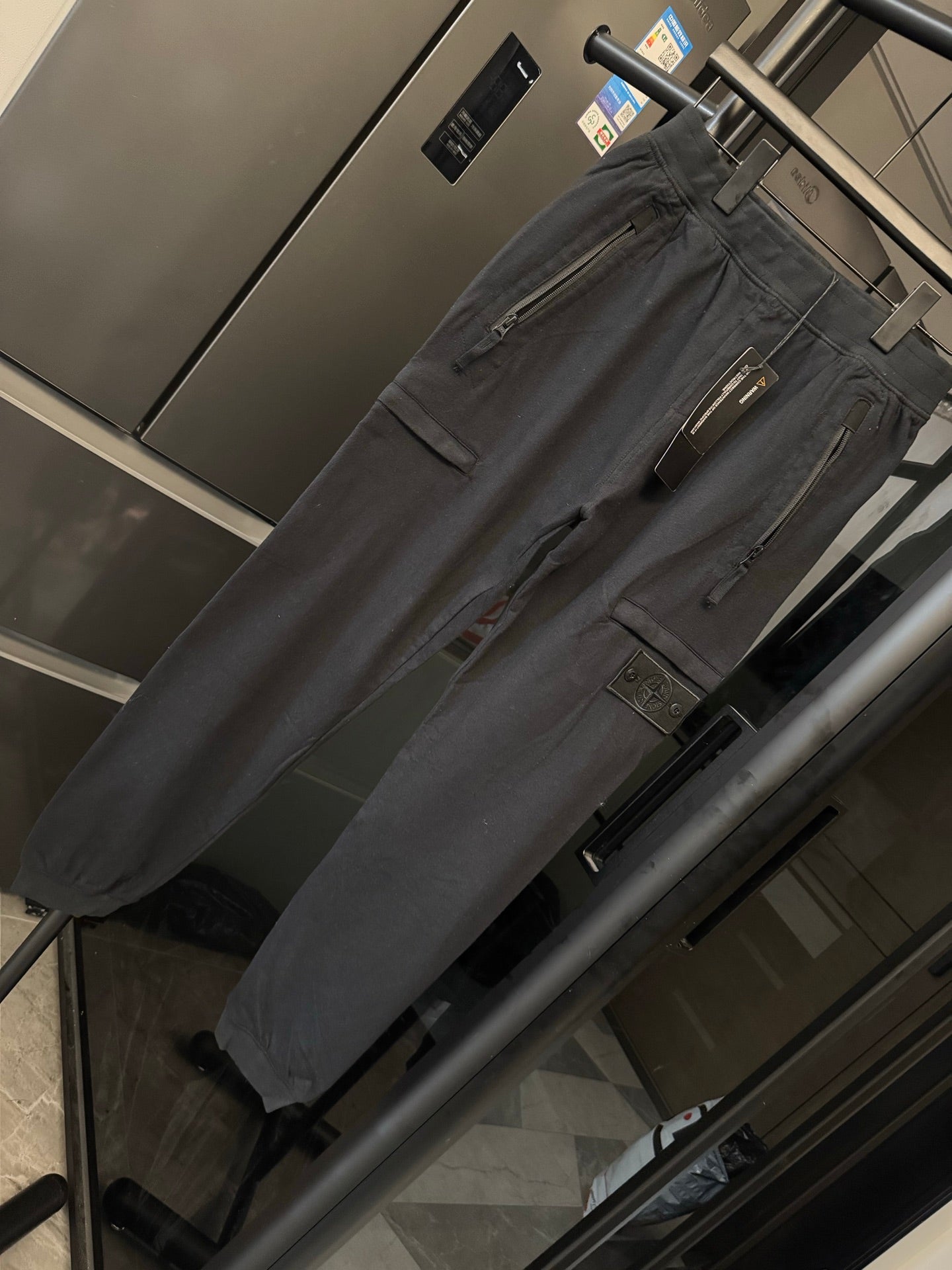 Stone Island cargo trousers, dark gray fabric with front zipper fly and utility pockets