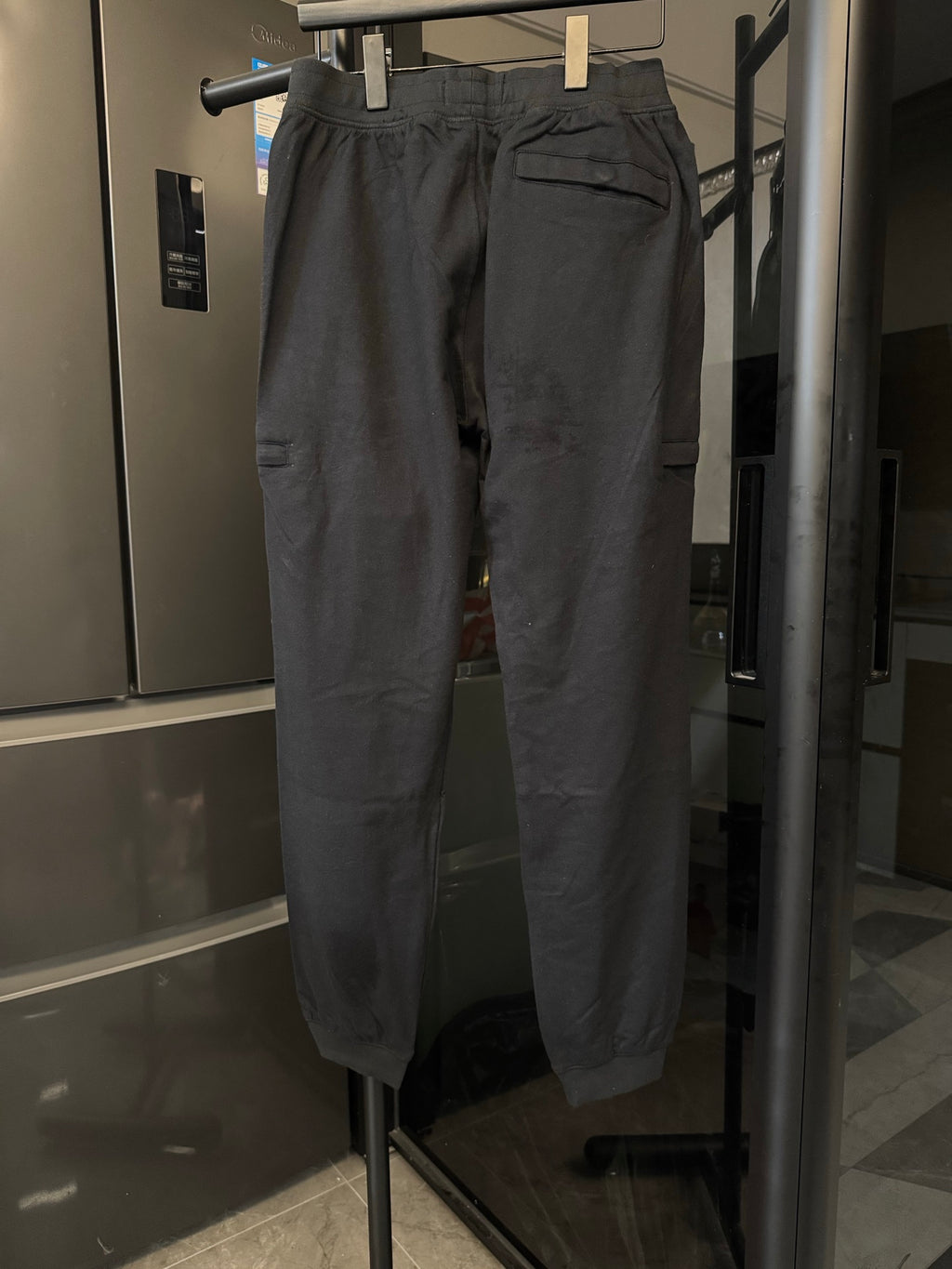 Stone Island cargo trousers, dark gray, back view with patch pockets and cargo side pockets