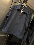 Dark navy long-sleeve zip jacket with pointed collar and small chest logo
