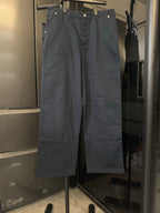 Navy blue straight-leg pants with button fly and belt loops