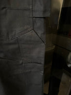 Dark blue pants close-up of stitched patch pocket and seams