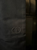 Embroidered circular Dior logo detail on dark blue pant pocket