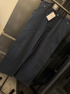 Blue denim-style wide-leg pants with front button closure