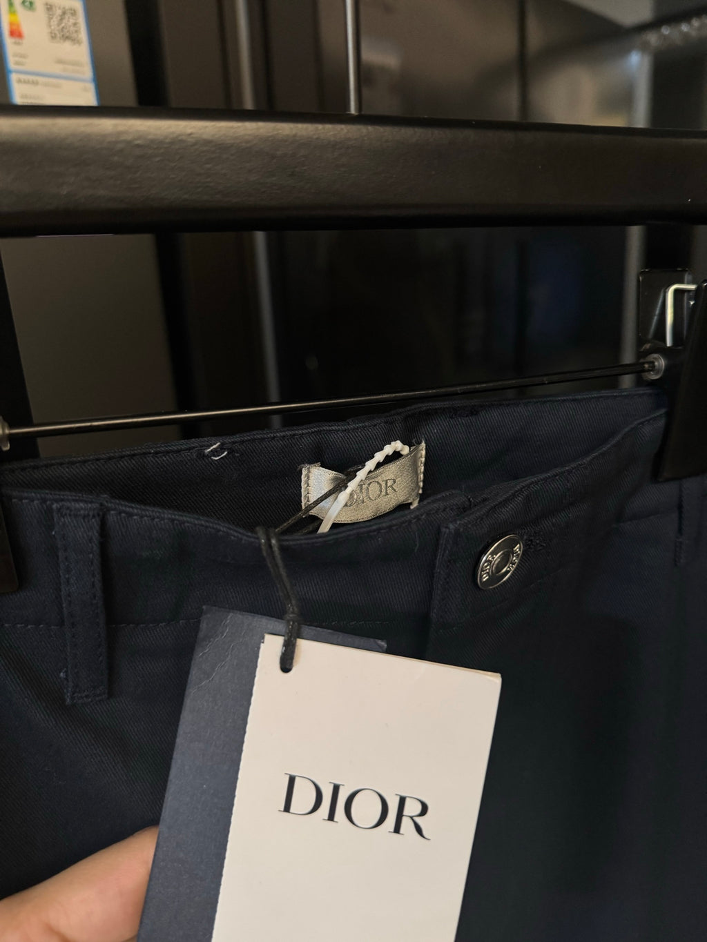 Dark blue pants waistband with Dior tag and silver button closure