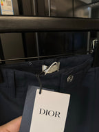 Dark blue pants waistband with Dior tag and silver button closure