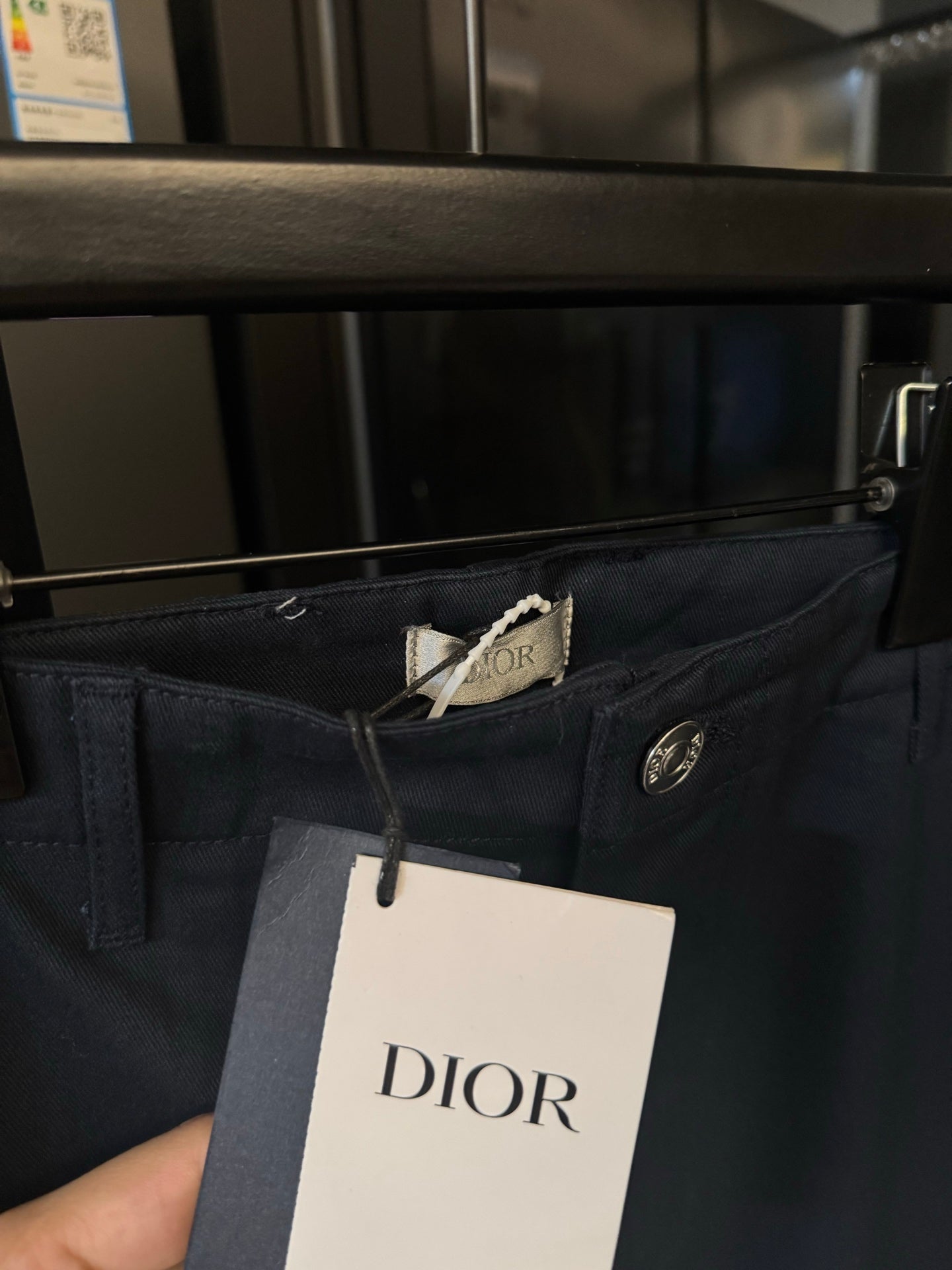 Dark blue pants waistband with Dior tag and silver button closure