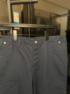 Dark blue chino pants with belt loops, front pleats, and side pockets