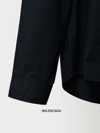 Black long-sleeve shirt with curved hem and sleeve cuffs.