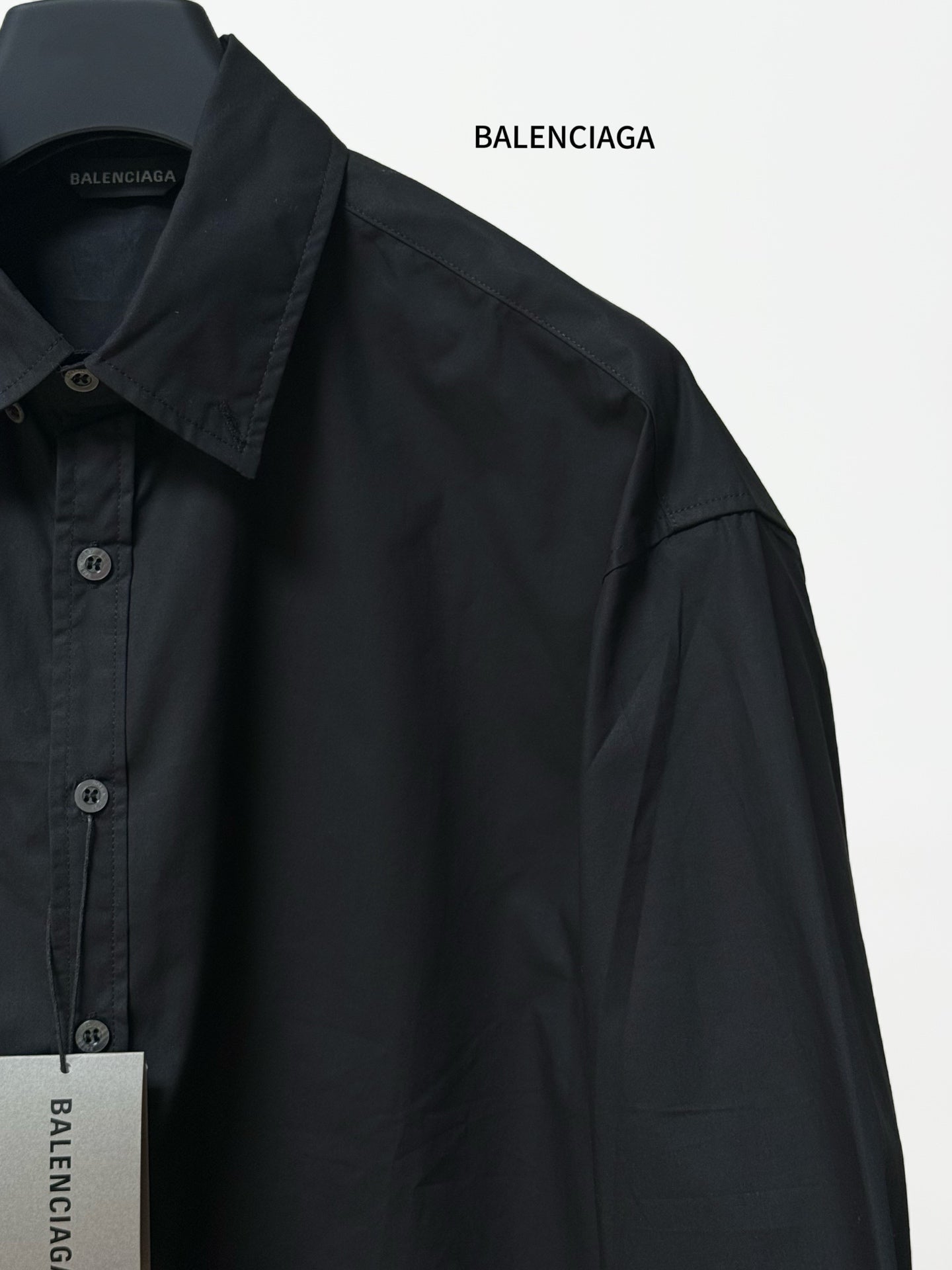 Balenciaga black long-sleeve button-up shirt with shoulder seam and curved side panel
