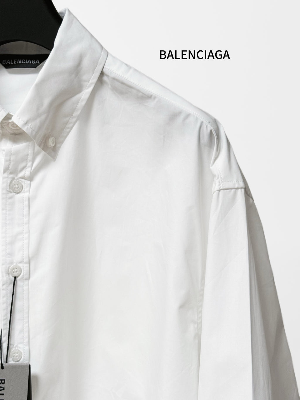 White long-sleeve shirt close-up of shoulder yoke and buttoned placket