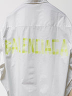 White long-sleeve button-up shirt, back view with neon green graphic across yoke