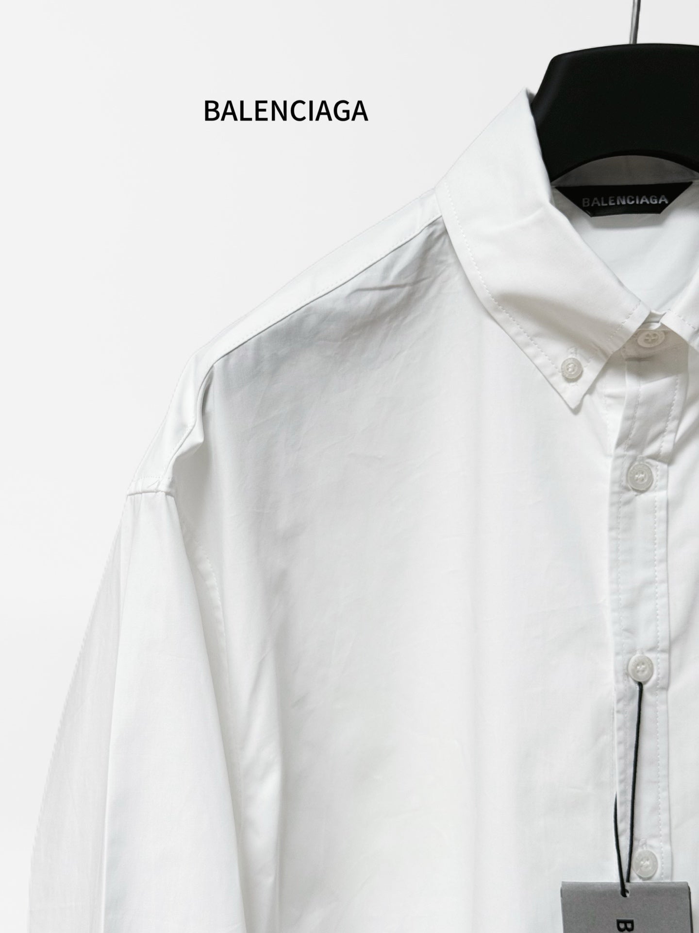 White button-up shirt close-up of pointed collar, front buttons and chest