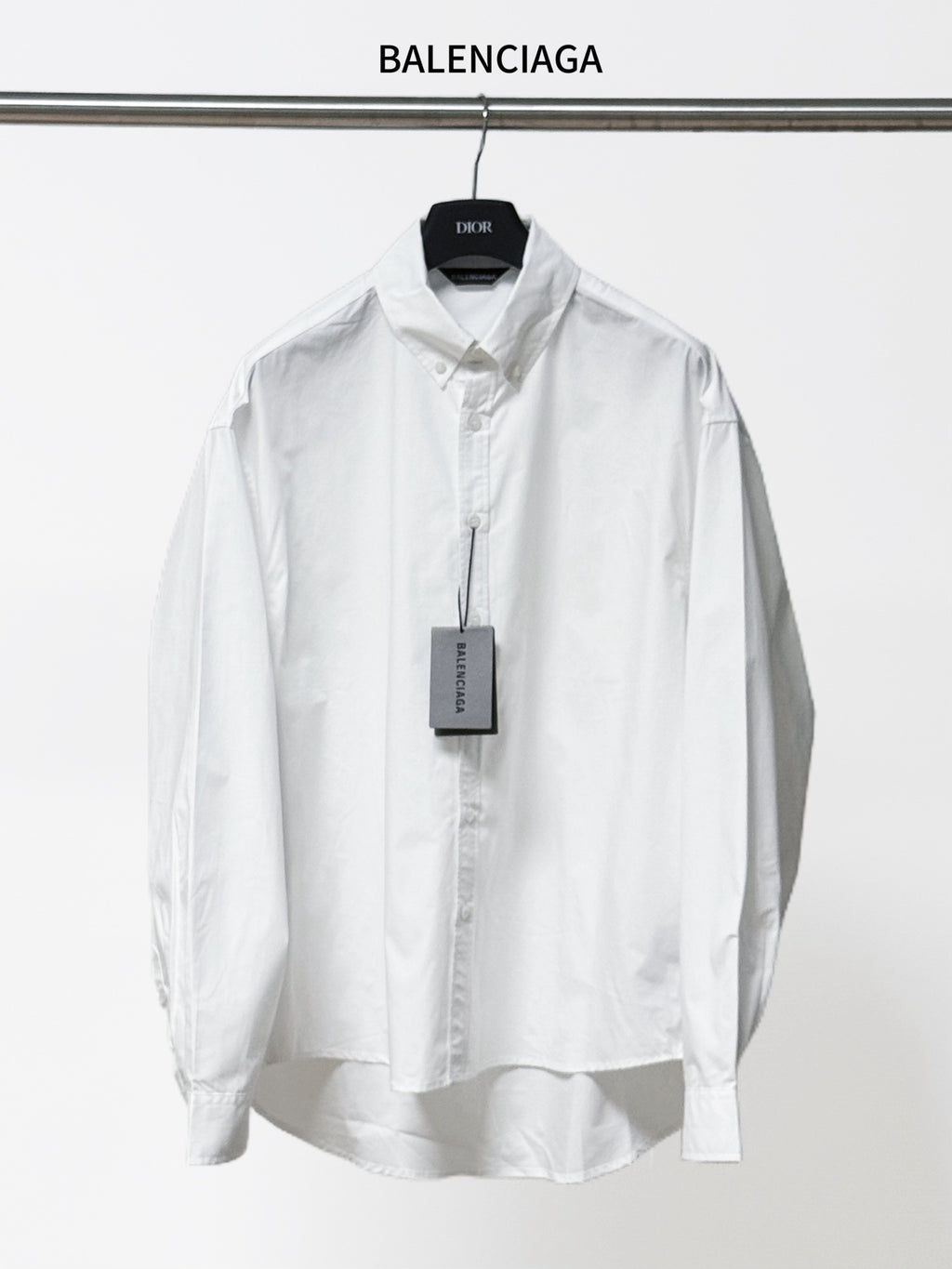 White long-sleeve button-up shirt with pointed collar and button placket, front view