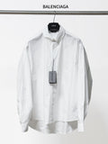 White long-sleeve button-up shirt with pointed collar and button placket, front view