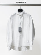 White long-sleeve button-up shirt with pointed collar and button placket, front view