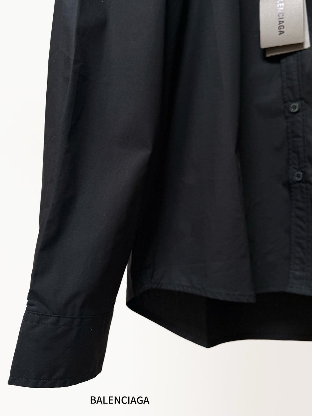 Balenciaga black long-sleeve shirt sleeve and lower hem with curved cut