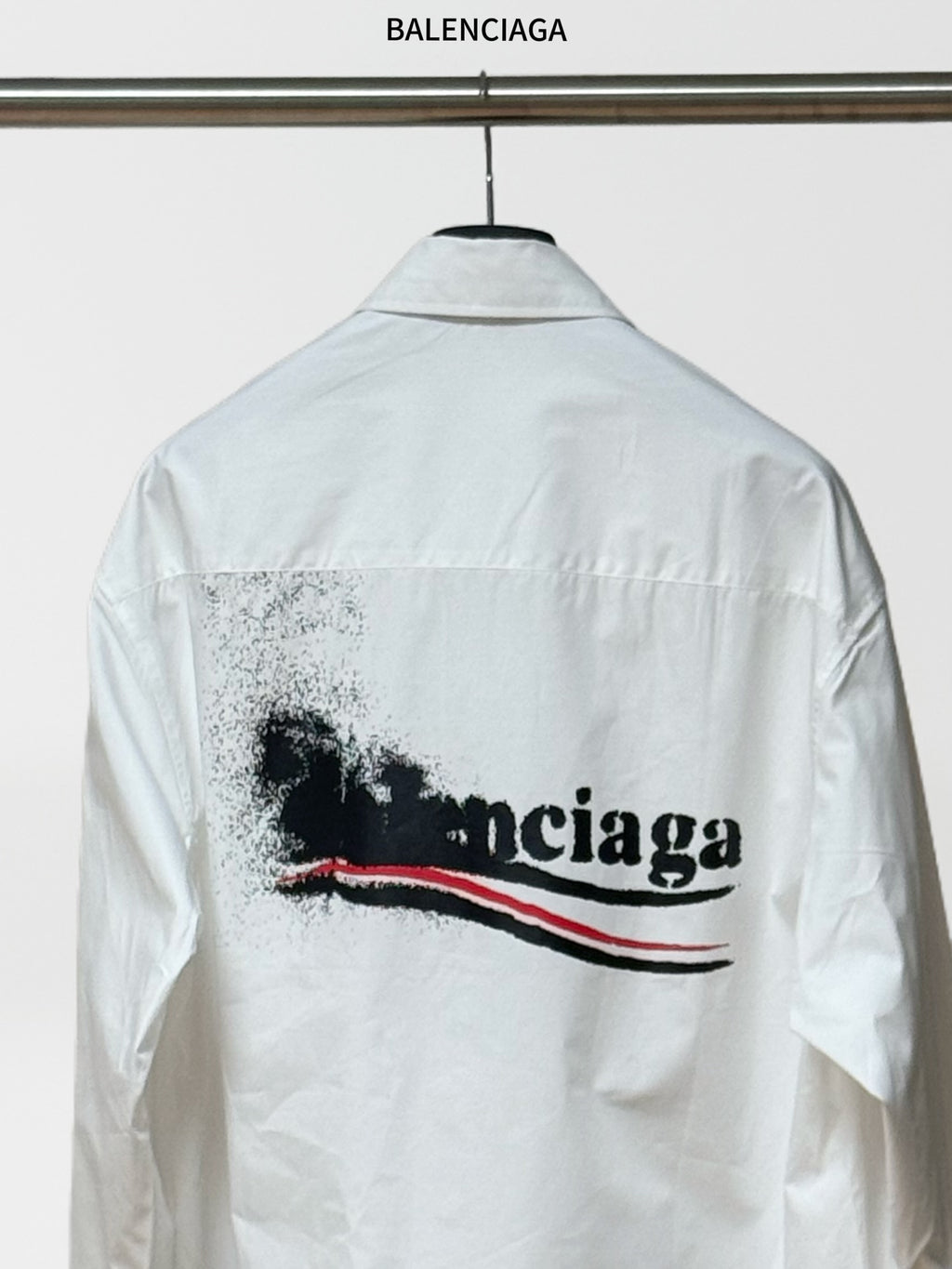 White button-up shirt with large back logo graphic and long sleeves