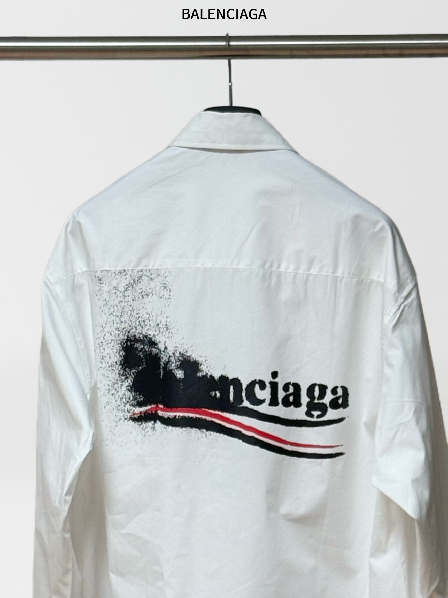 White button-up shirt with large back logo graphic and long sleeves