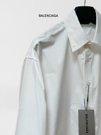 White button-up shirt with pointed collar and front buttons; long sleeves; BALENCIAGA tag