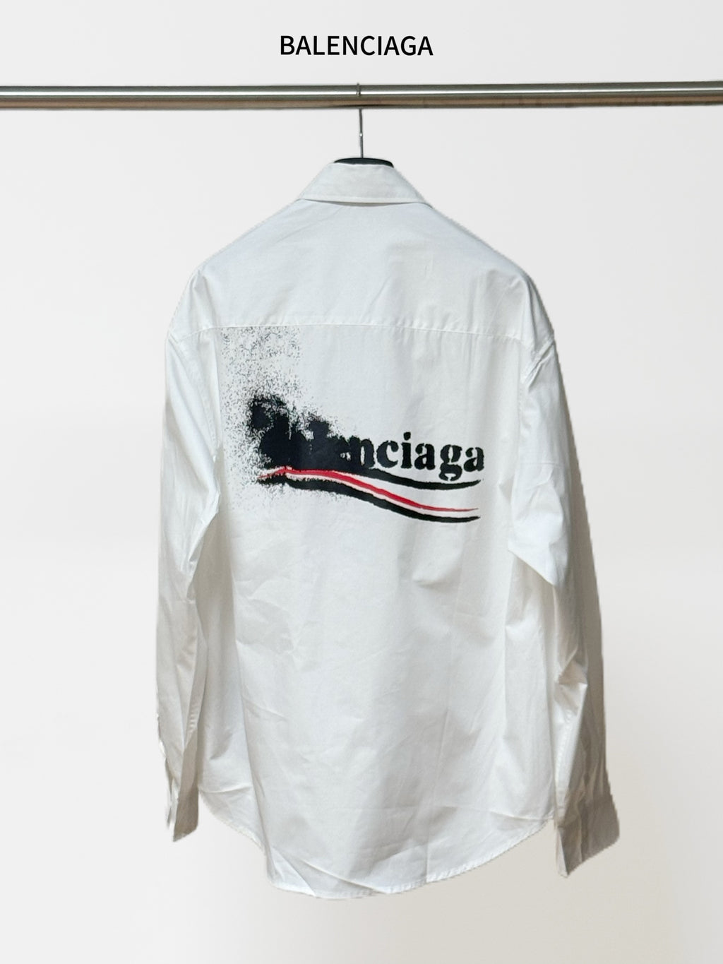 White button-up shirt with long sleeves and back graphic logo; BALENCIAGA label