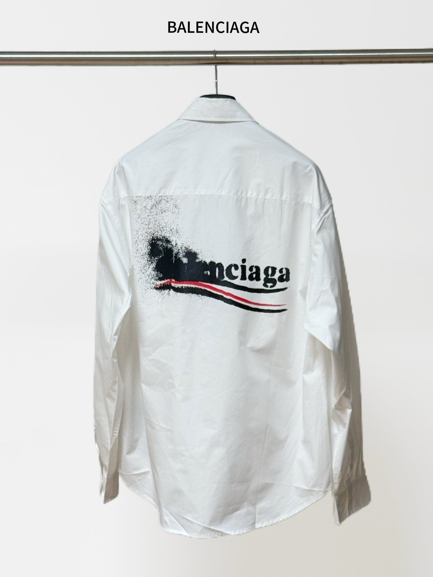 White button-up shirt with long sleeves and back graphic logo; BALENCIAGA label