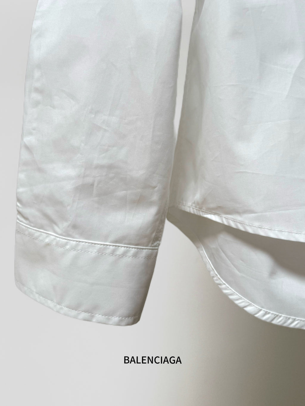 White shirt sleeve cuff with stitched hem and side seam detail