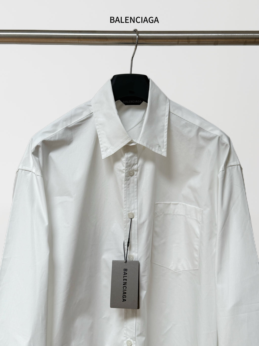 White button-up shirt with pointed collar, front placket, and chest pocket; BALENCIAGA tag