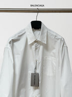 White button-up shirt with pointed collar, front placket, and chest pocket; BALENCIAGA tag