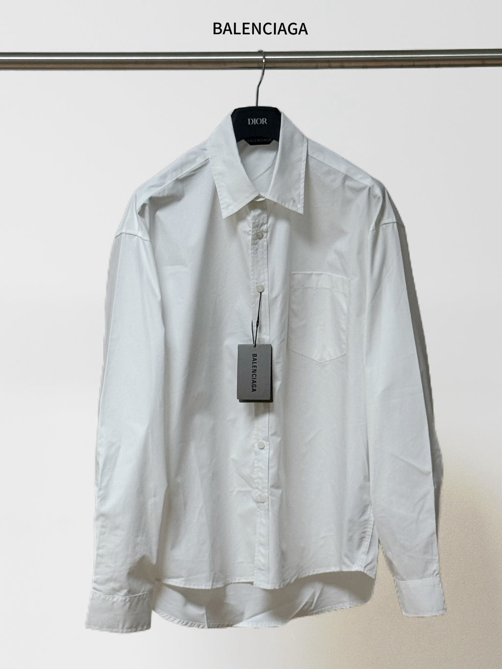 White button-up shirt with pointed collar, long sleeves, chest pocket; BALENCIAGA tag