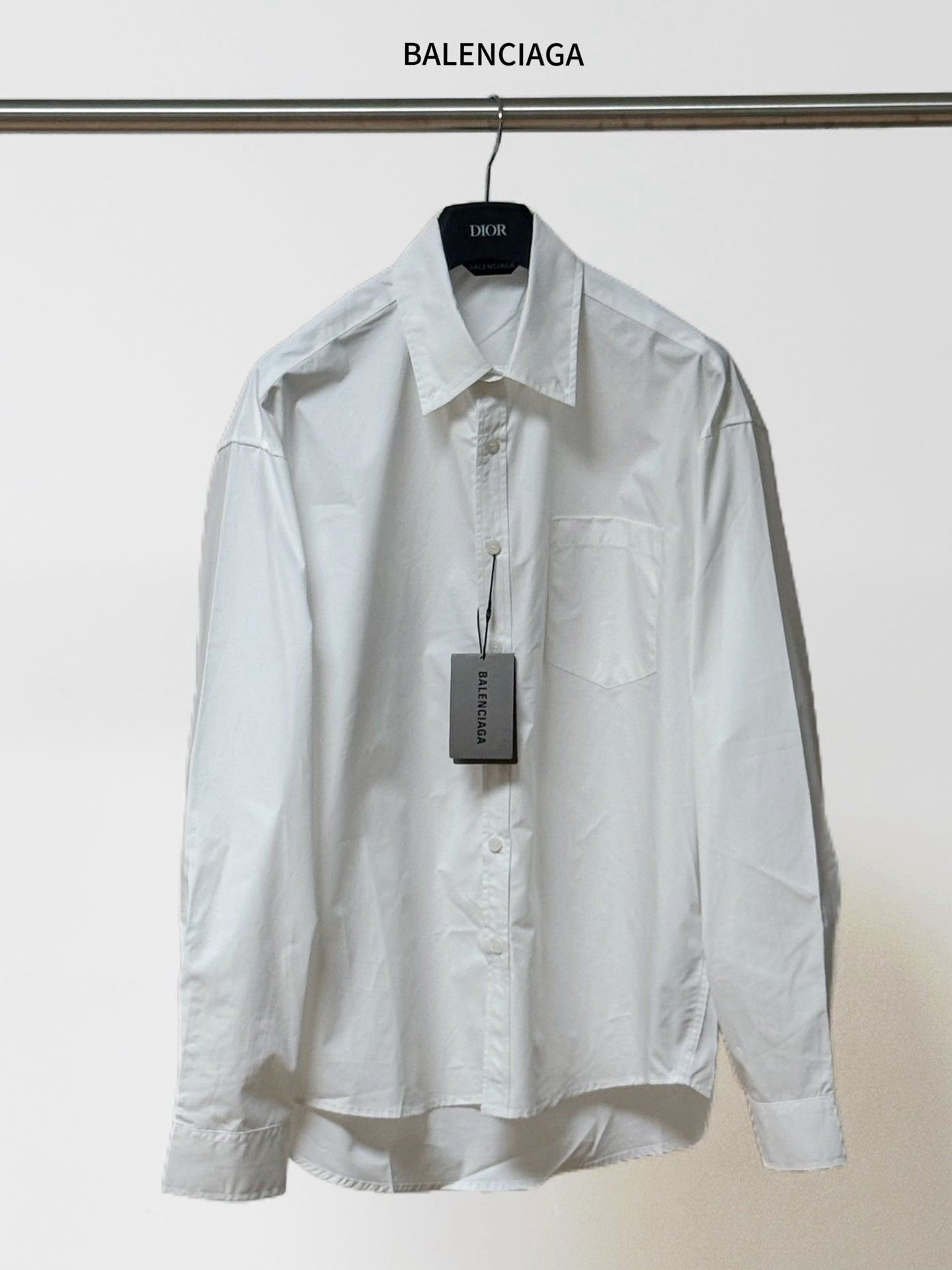 White button-up shirt with pointed collar, long sleeves, chest pocket; BALENCIAGA tag