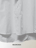 White button-up shirt front with button placket and curved hem