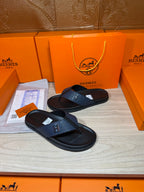 Luxury leather sandals with dark navy H-style strap and black flip-flop sole