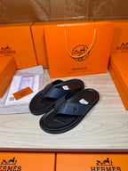 Luxury leather sandals with dark navy thong straps and black textured footbeds