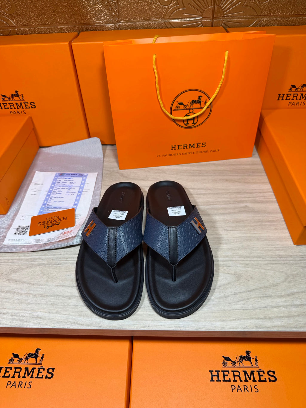 Luxury leather sandals in dark navy with wide toe straps and contoured black soles